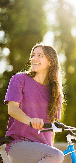 uruguayan-latin-woman-ride-bike-smiling-outdoor-eco-friendly-sustainable-bicycle-transport